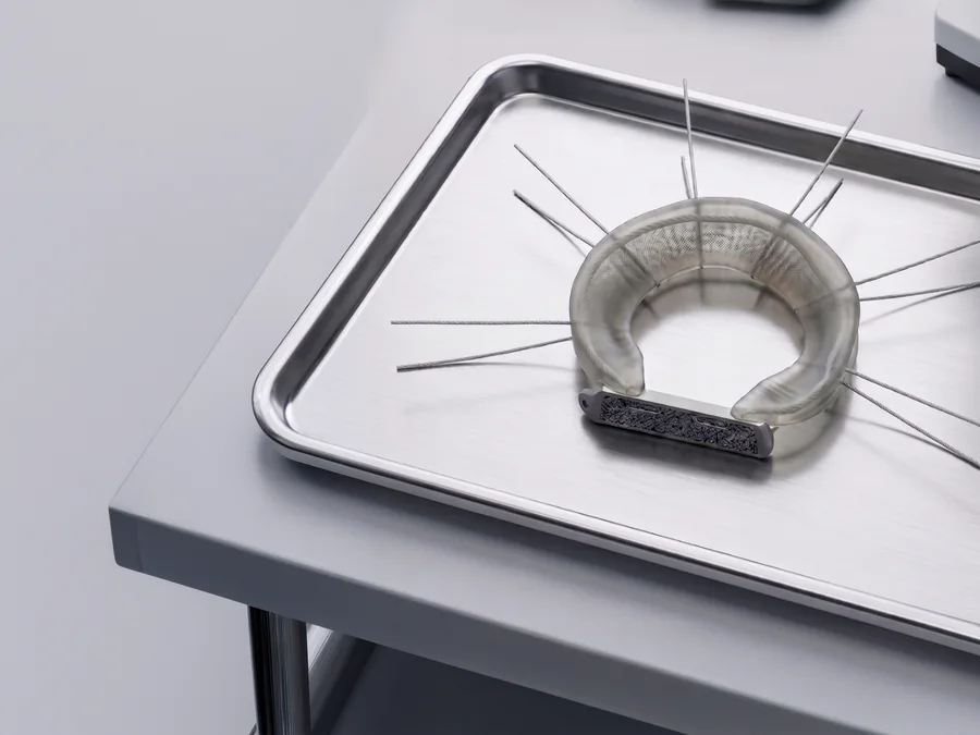 A LunaFlex implant on a stainless steel instrument tray in a laboratory.